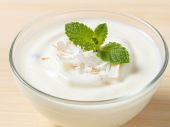 Creamy coconut milk yogurt in a bowl with toppings.