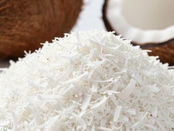 Desiccated coconut flakes and whole coconuts